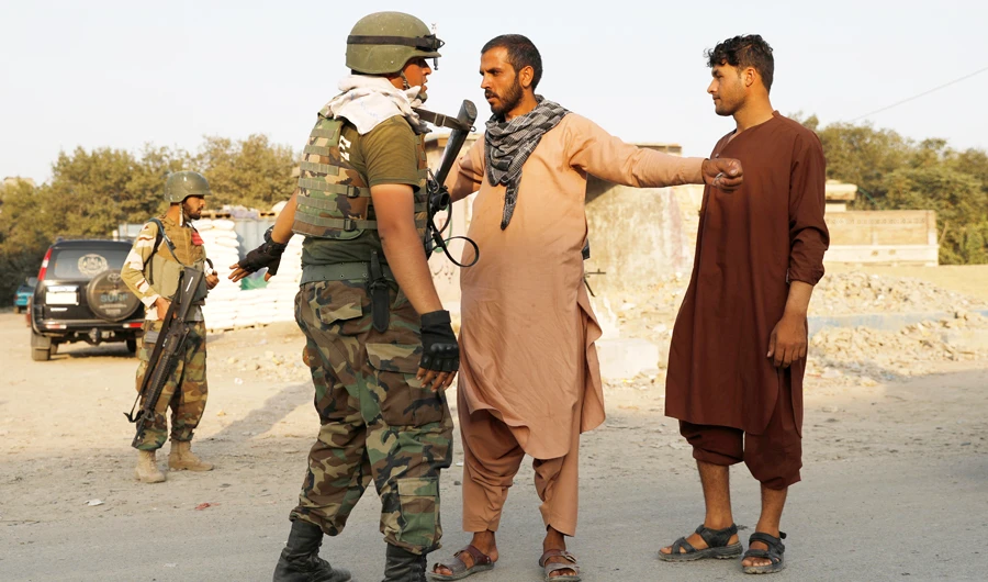 An Afghan National Army (ANA) soldier inspects passengers at a checkpoint in Kabul, Afghanistan September 25, 2019. (REUTERS)
