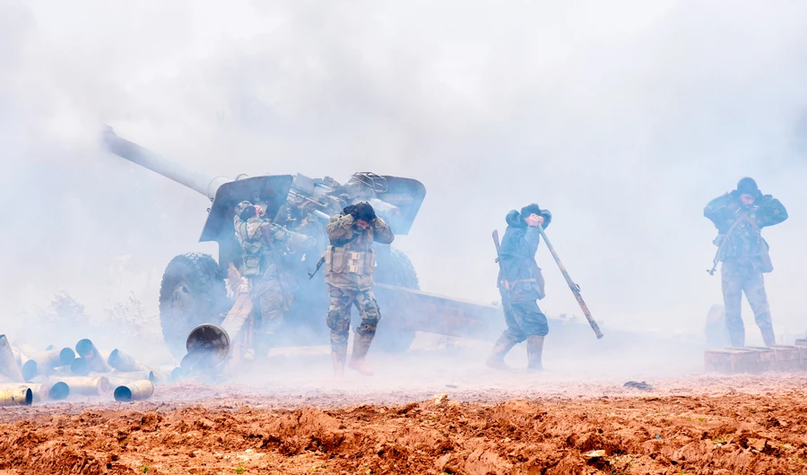 A handout picture released by the official Syrian Arab News Agency (SANA) on January 2, 2020 shows Syrian government forces firing at positions of rebel fighters in the countryside of Maaret al-Numan. (AFP)