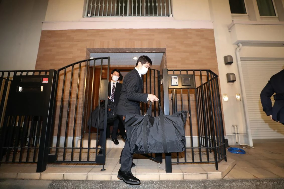 Japanese prosecutors carry bags on January 2, 2020 as they leave the residence of former Nissan boss Carlos Ghosn, who jumped bail and fled to Lebanon. (Jiji Press/AFP)