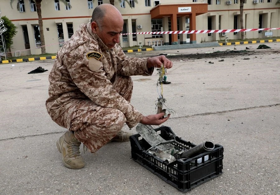 A member of the Government of National Accord inspects the site of an attack on a military academy in Tripoli on Sunday, January 5, 2020. (Reuters)