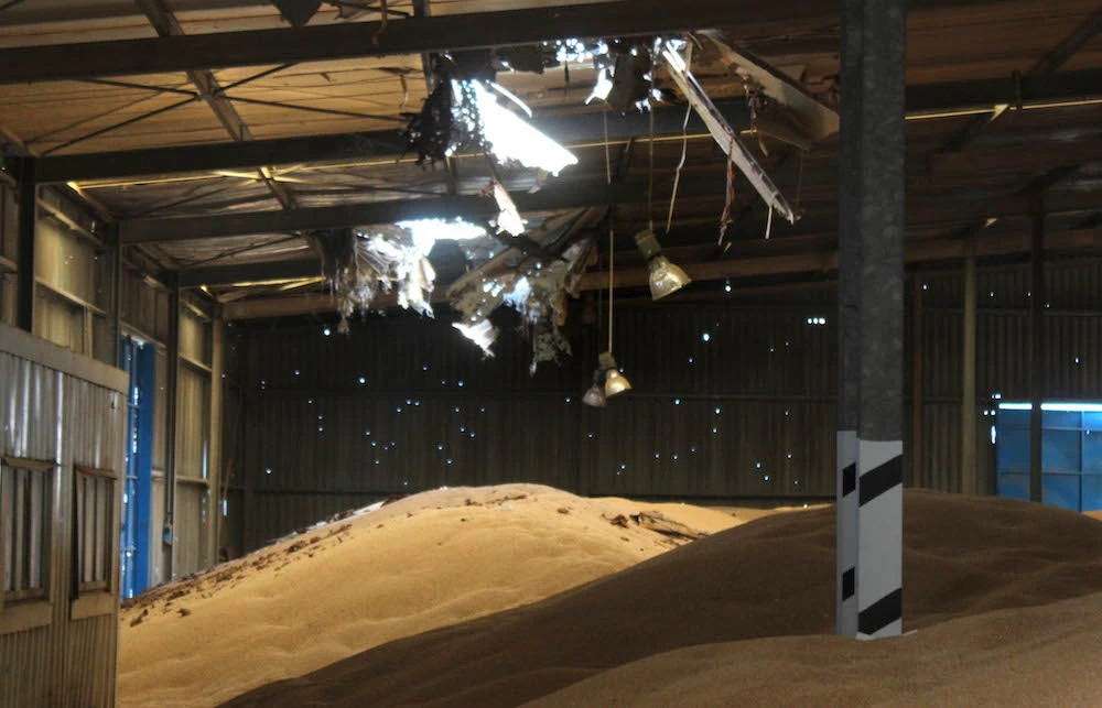 Piles of grains lie at a damaged warehouse of Yemen's Red Sea mills company in the port city of Hodeidah. (File/AFP)
