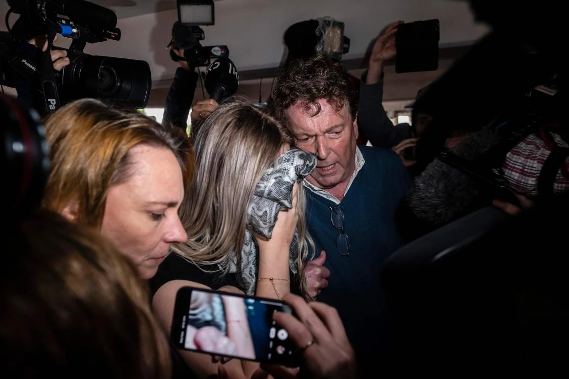 The British teenager, with face covered, said she was coerced into retracting an accusation she was gang-raped. (AFP)