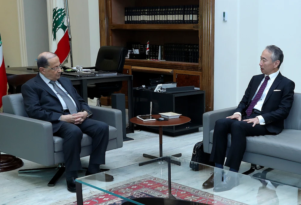 Lebanese president Michel Aoun with Japan's Ambassador to Lebanon Takeshi Okubo in the presidential palace, in Baabdaon Tuesday. (AP)