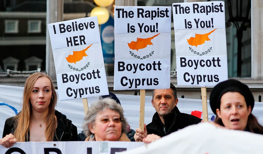 Demonstrators hold placards calling for a boycott on Cyprus, and in support of a British teenager convicted of lying about being raped by Israeli tourists, as they protest in London on January 6, 2020. (AFP)