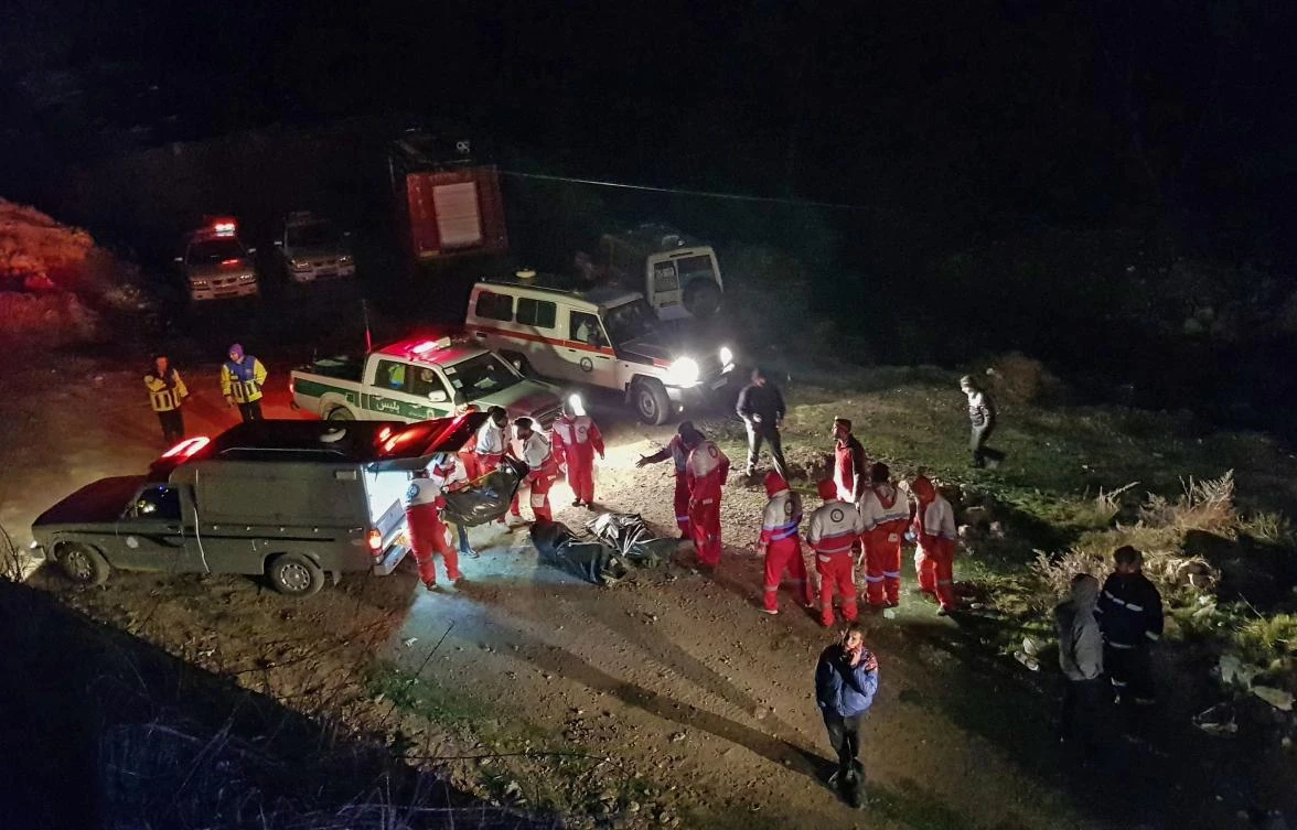 This handout picture provided by the Iranian Mizan News Agency on January 9, 2020 shows Iranian Red Crescent paramedics recovering bodies at the scene of a bus accident that plunged off a mountain road into a ravine in Mazandaran province, 150 kilometres (90 miles) northeast of Tehran. (AFP)
