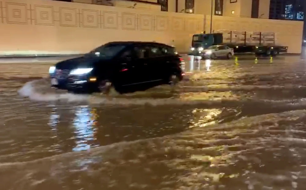 Cars drive through flooded streets in Dubai on Saturday. (Reuters)