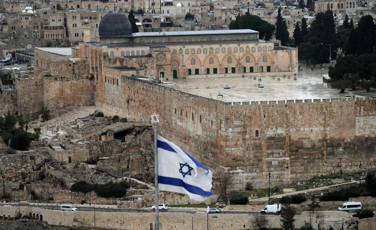 An Israeli flag flutters at Mount of Olives with the Old City of Jerusalem and its al Aqsa Mosque (L) on January 9, 2020. (AFP)