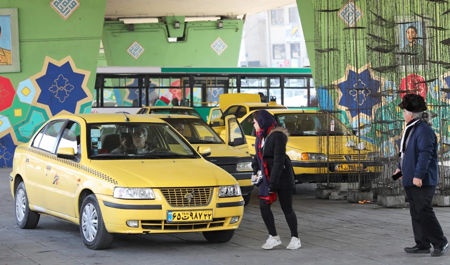 Iranians walk through a taxi stop off a main square in the Islamic republic's capital Tehran on January 11, 2020. (AFP)