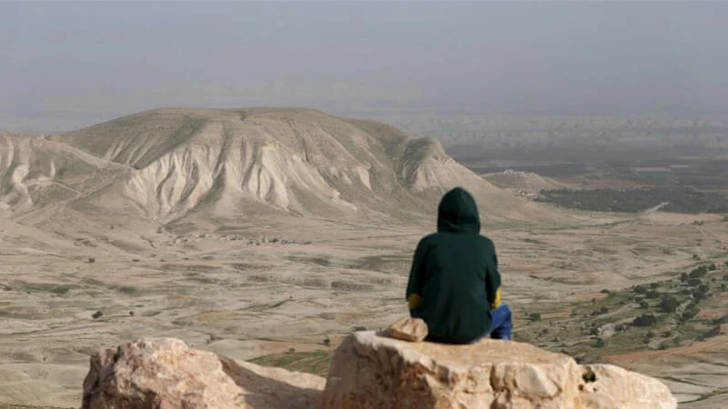 A Palestinian youth looks out on the Jordan Valley near the West Bank city of Jericho. (Reuters)