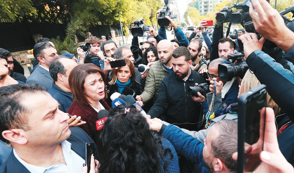 Lebanese Caretaker Interior Minister Raya Al-Hassan speaks to journalists as they protest in front of the Interior Ministry in Beirut on Thursday. (Reuters)