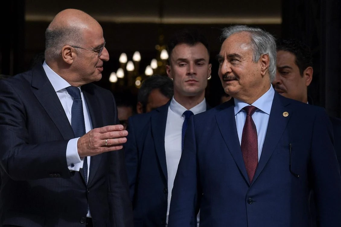 Greek Foreign Minister Nikos Dendias, left, and Libyan strongman Khalifa Haftar in Athens — days ahead of a peace conference in Berlin which Haftar and the head of Tripoli’s UN-recognized government are expected to attend. (AFP)