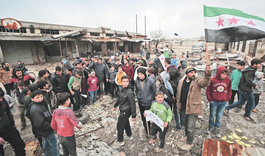 Syrians take part in a demonstration against the offensive by the Bashar Assad regime in Syria’s last major opposition bastion of Idlib province on Friday. (AFP)