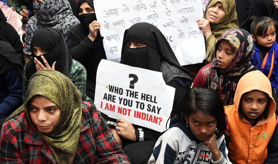 In this file photo taken on January 6, 2020, protesters hold placards as they listen to speakers in the Shaheen Bagh, which has been blocked off by demonstrators protesting against India's new citizenship law, near the Jamia Millia Islamia university in New Delhi. (AFP)