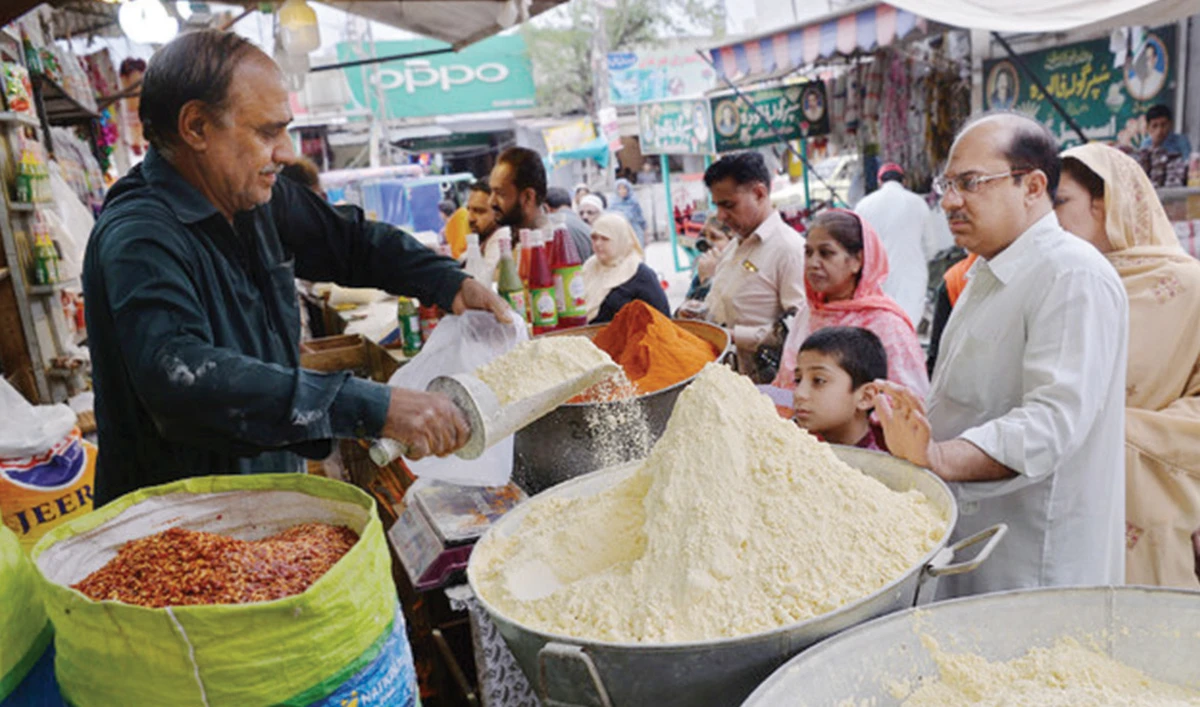 Pakistanis buy flour and other items ahead of the start of Ramadan in Rawalpindi in this file photo. Rising flour prices prompted government crackdown on hoarders. (AFP)