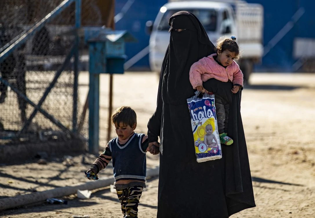 A woman walks with children inside the Kurdish-run Al-Hol camp for the displaced in the al-Hasakeh governorate in northeastern Syria on January 14, 2020, at the section reserved for Iraqis and Syrians. (File/AFP)