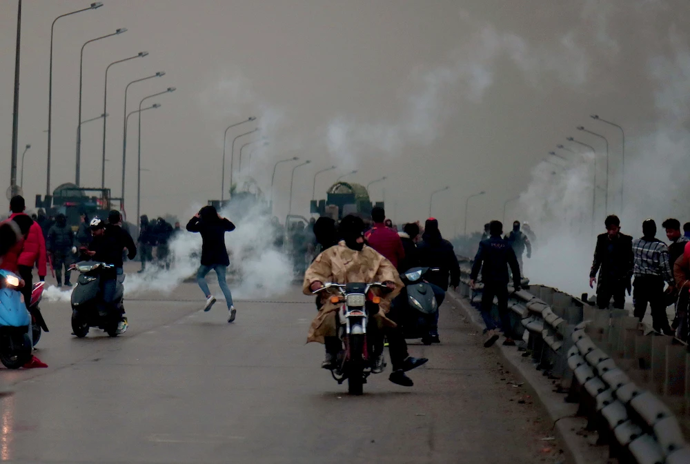Security forces fire tear gas on a key highway that was closed by anti-government protesters in Baghdad, Iraq, Wednesday, Jan. 22, 2020. (AP)