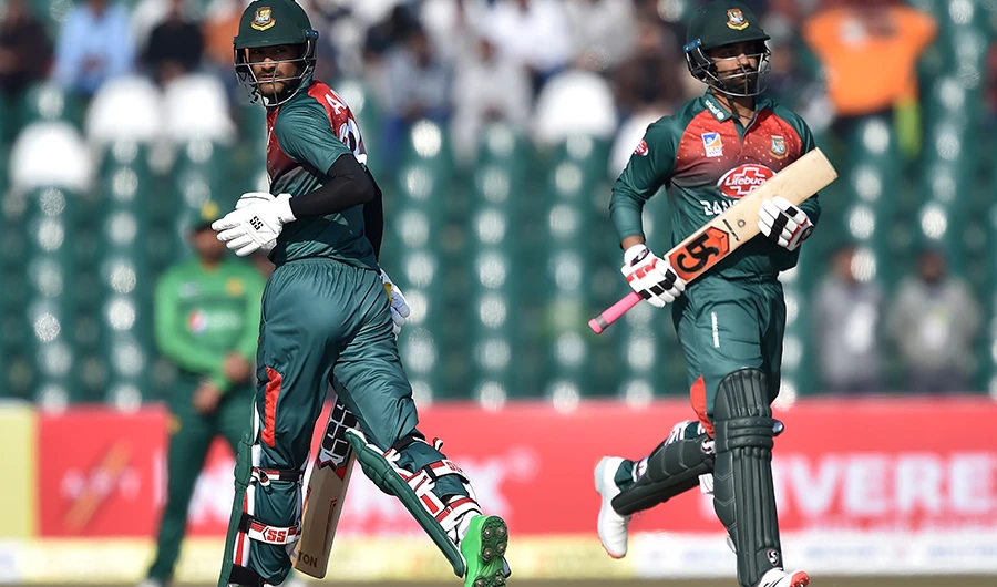 Bangladesh's Mohammad Naim (L) and Tamim Iqbal run between the wickets during the first T20 international cricket match of a three-match series between Pakistan and Bangladesh at Gaddafi Cricket Stadium in Lahore on January 24, 2020. (AFP)