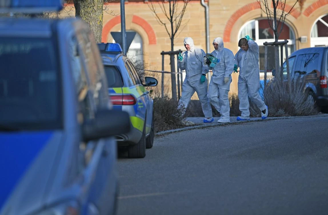 German forensic policemen walk near a house where a shooter killed six people in Rot am See in southwestern Germany. (AFP)
