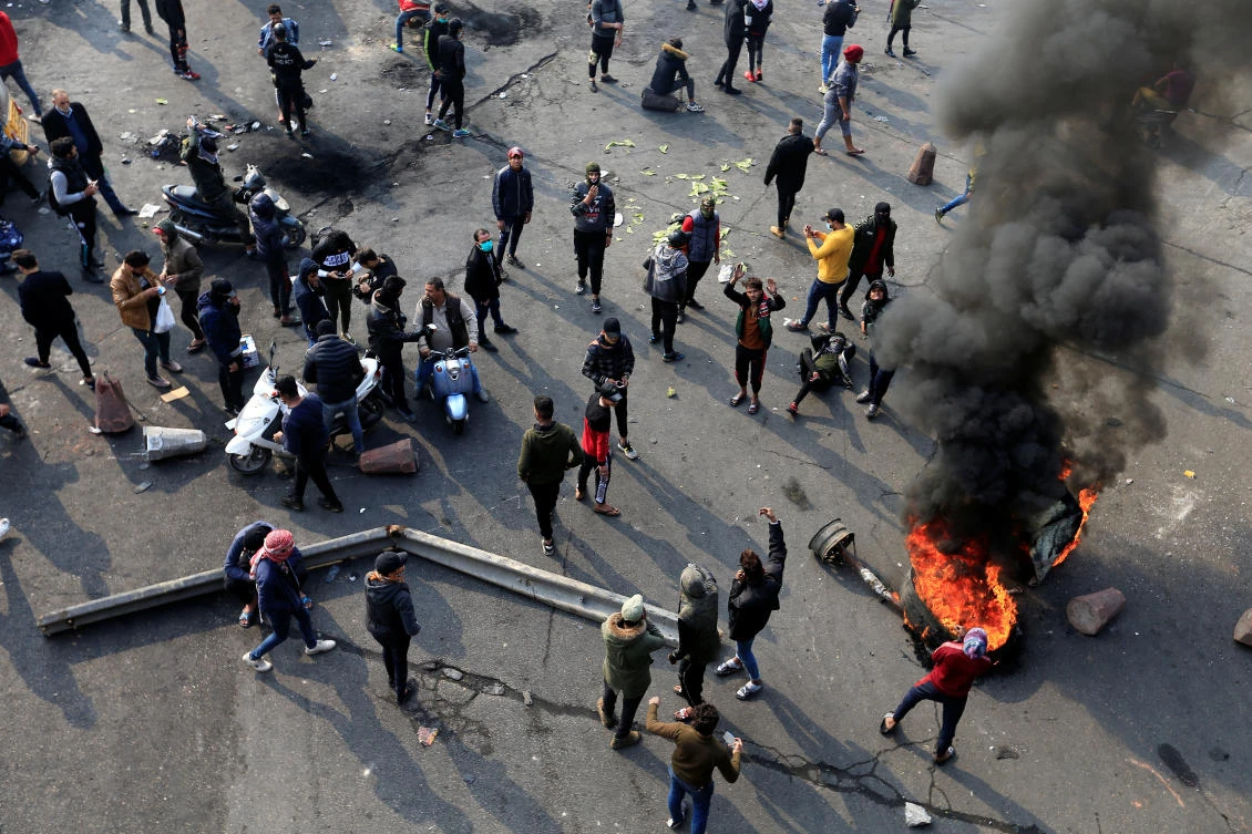 Iraqi demonstrators burn tires as they block a road during ongoing anti-government protests, in Baghdad, Iraq January 23, 2020. (Reuters)