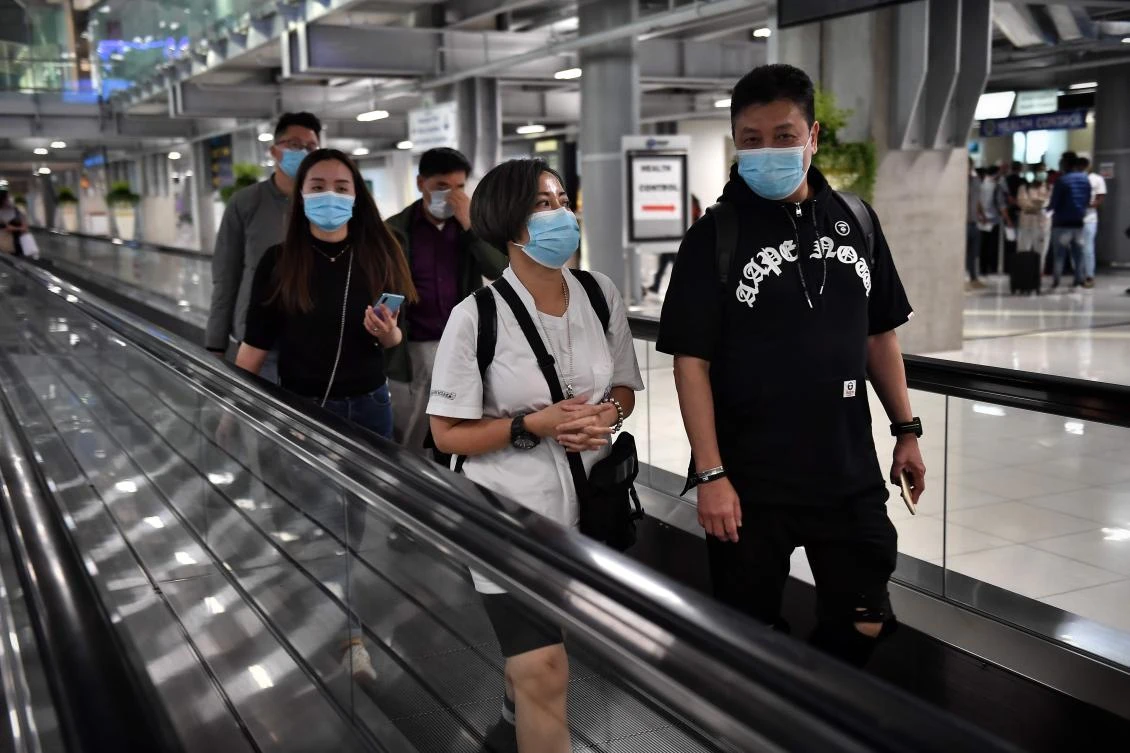 Arriving passengers wearing masks disembark at Suvarnabhumi International Airport in Bangkok on January 24, 2020. (AFP)