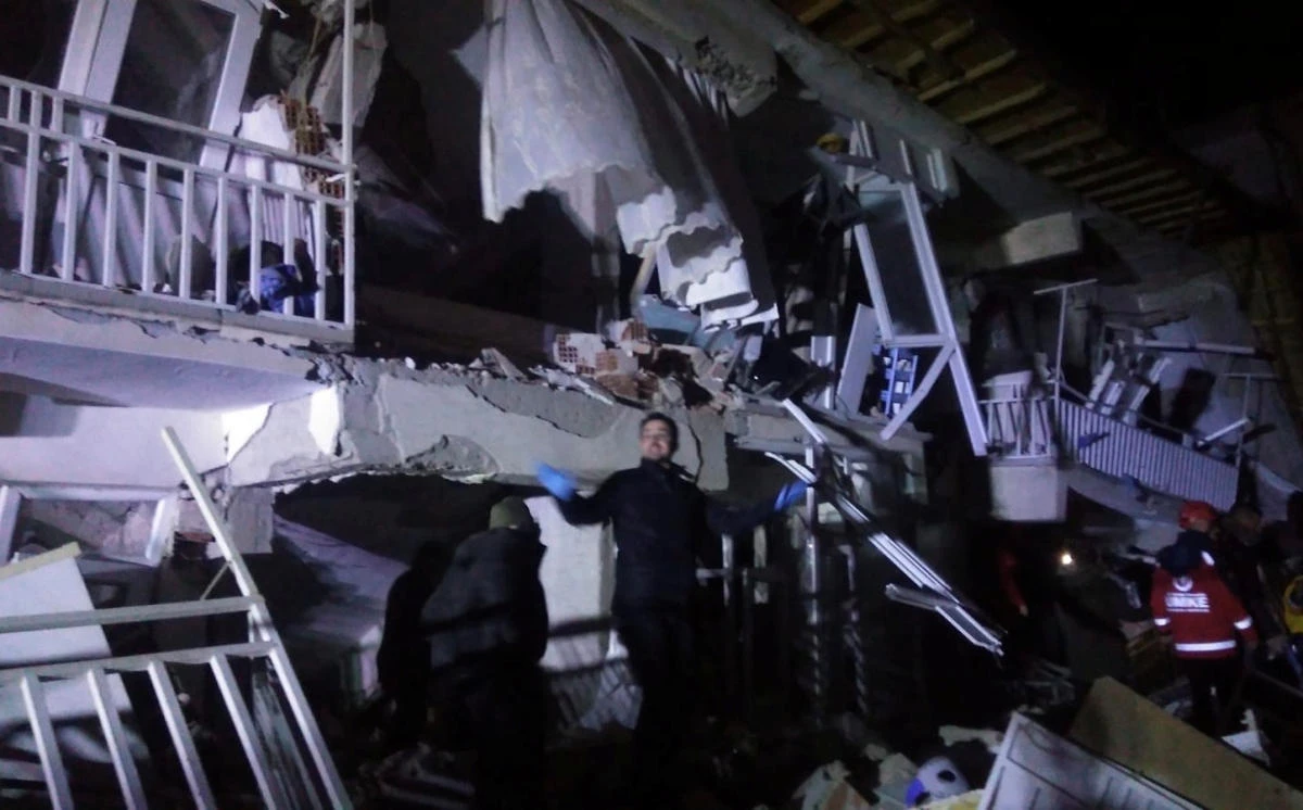 Rescuers are seen outside a collapsed building after an earthquake in Elazig, Turkey. (Reuters)