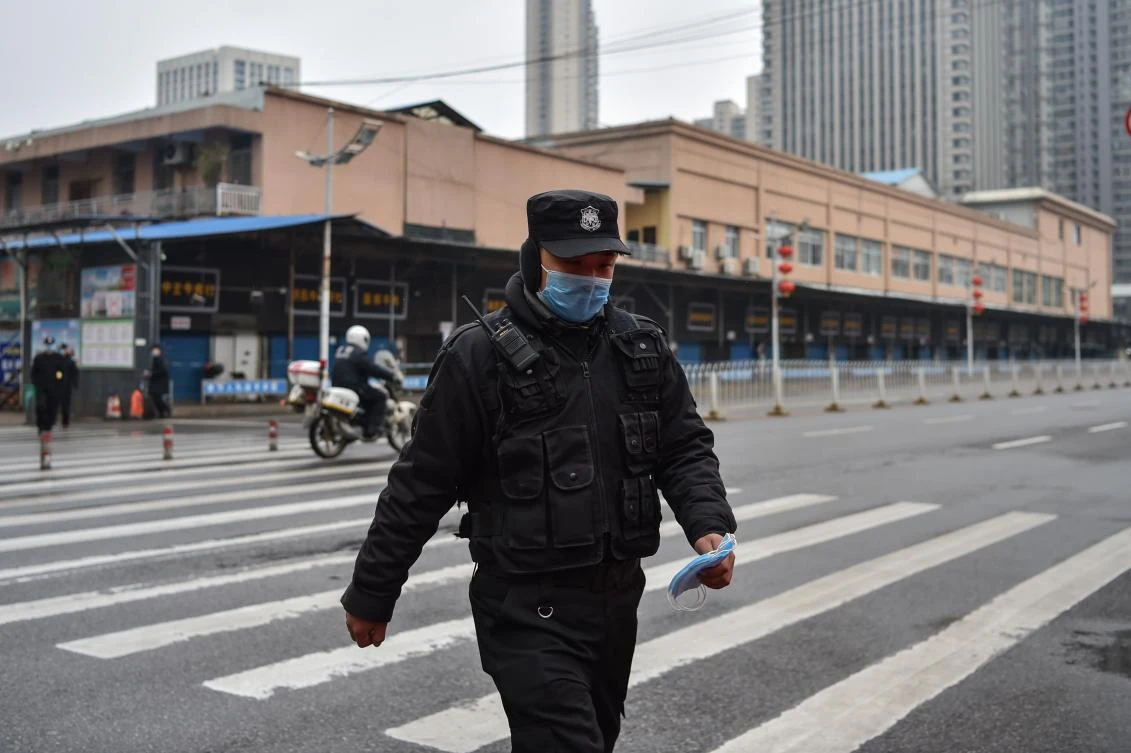 A police officer walks in front of Huanan Seafood Wholesale market in Wuhan on Jan. 24, 2020. (AFP)