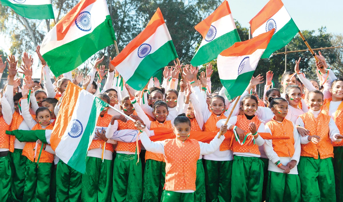Children wave Indian flags during a full-dress rehearsal ahead of Republic Day celebrations in Amritsar. (AFP)