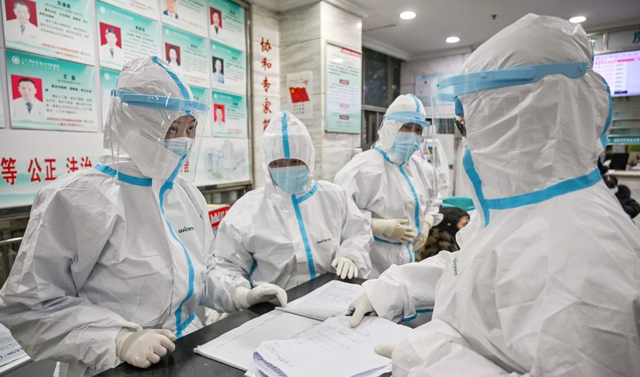 Medical staff members wearing protective clothing to help stop the spread of a deadly virus which began in the city, work at the Wuhan Red Cross Hospital in Wuhan on January 25, 2020. (AFP)