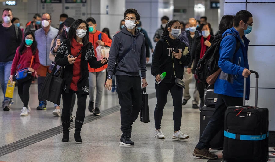 People wearing facemasks walk through a train station on the second day of the Lunar New Year of the Rat in Hong Kong on January 26, 2020, as a preventative measure following a coronavirus outbreak which began in the Chinese city of Wuhan. (AFP)