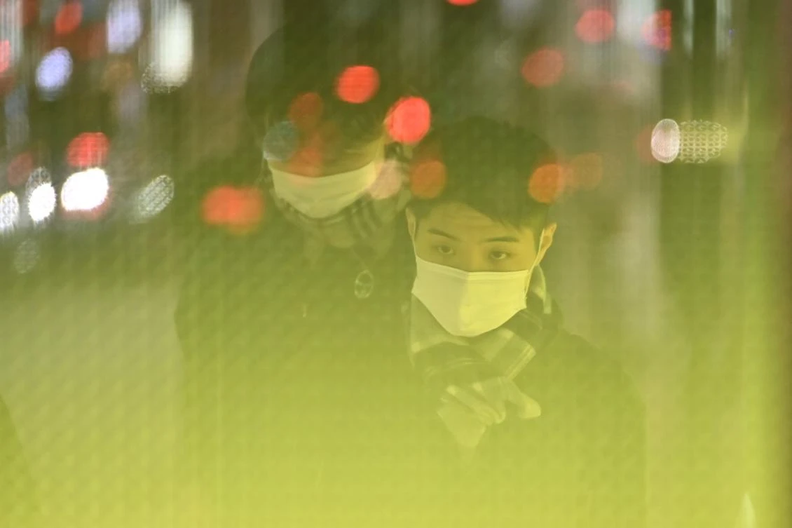 Pedestrians wearing protective masks to help stop the spread of a deadly virus which began in the Chinese city of Wuhan, walk on a street in Tokyo's Ginza area on January 26, 2020. Japan's health authorities on January 26 confirmed the country's fourth case of the coronavirus which emerged in the Chinese city of Wuhan. (AFP)