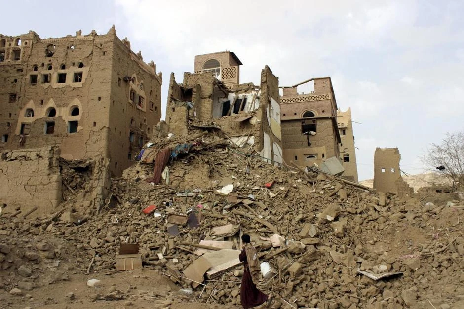A man walks past houses damaged by Saudi-led airstrikes in Yemen's northwestern city of Saada May 26, 2015. Picture taken May 26, 2015. (Reuters)