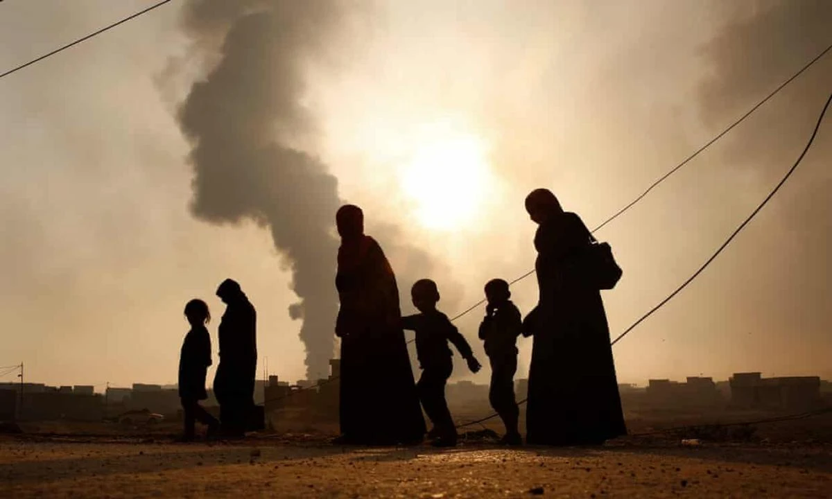 A family walks away from the front line in Mosul, Iraq. (Getty Images)