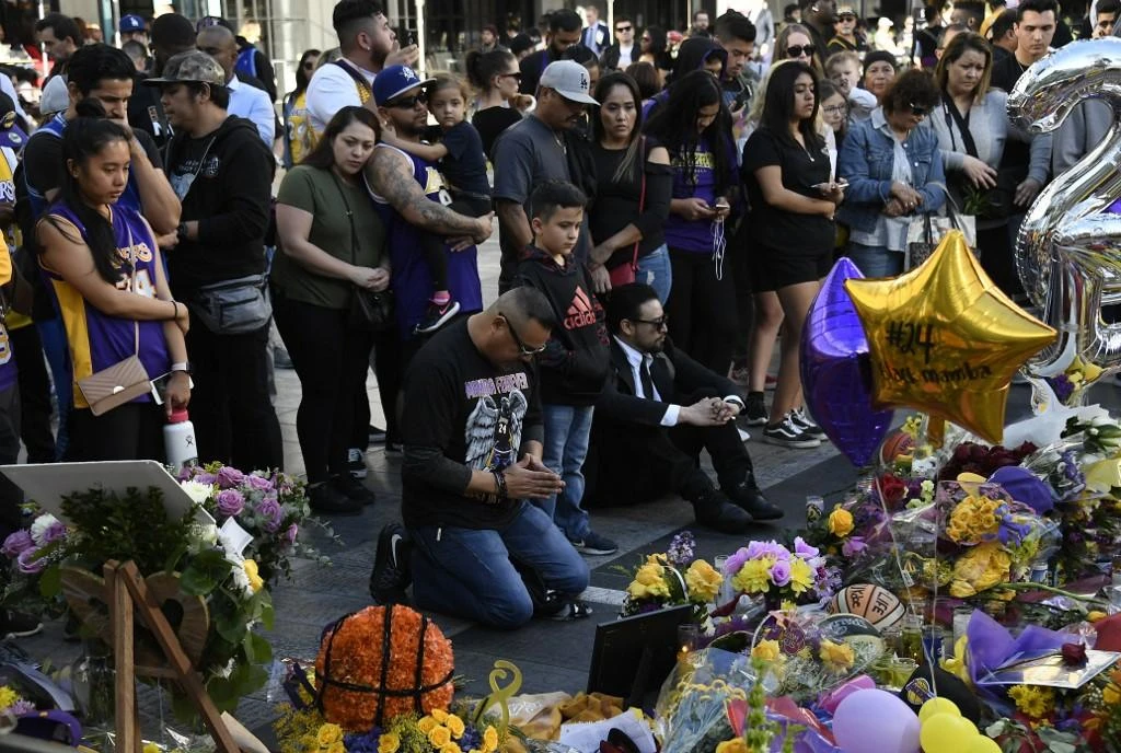 Fans pay their respects to Kobe Bryant and his daughter Gianna, 13, at a memorial set up outside of Staples Center on January in Los Angeles, California. (AFP)