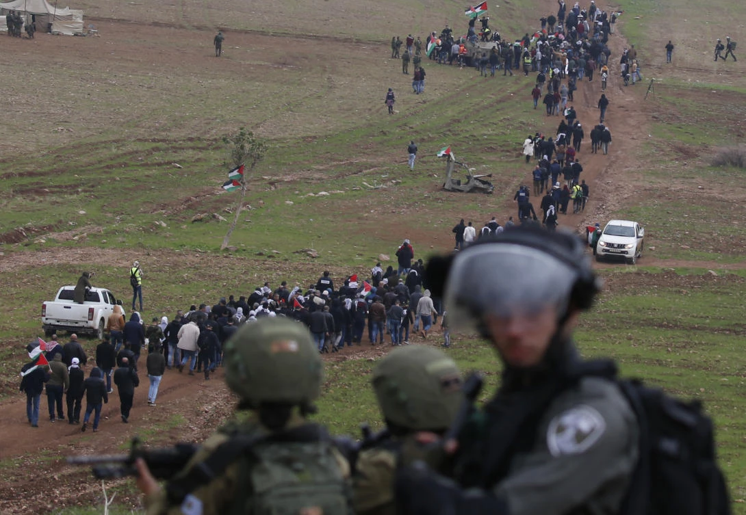 Israeli security forces monitor Palestinian demonstrators protesting near the West Bank village of Tubas, near the Jordan Valley, in the occupied West Bank on January 29, 2020, during a demonstration against the US President Donald Trump's peace proposals. (AFP)