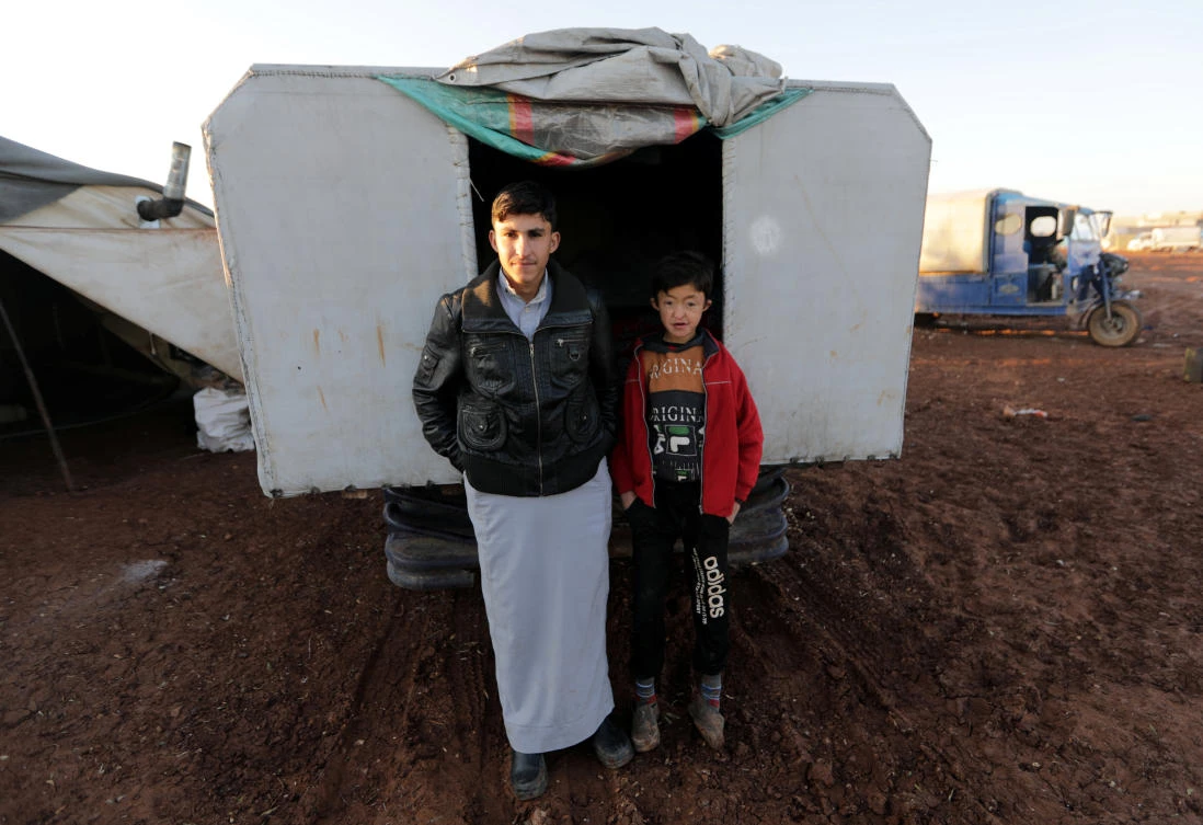 Displaced Syrians are pictured in front of a truck in Azaz, Syria January 22, 2020. Picture taken Jan. 22, 2020. (Reuters)