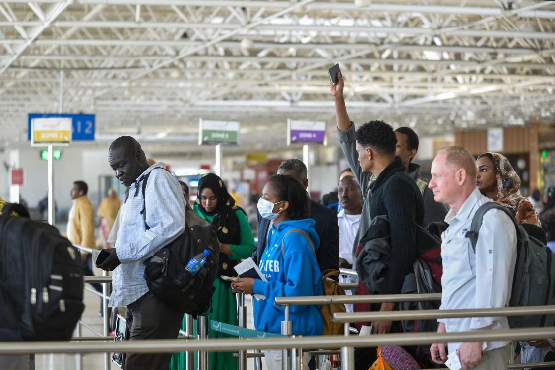 A passenger wears a mask as she waits at passport control in Bole International Airport, Addis Ababa, following the outbreak of the coronavirus in China. (AFP)
