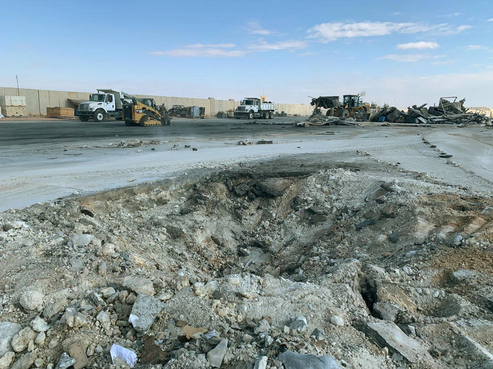 In this Jan. 13, 2020 file photo, Iranian bombing caused a crater at Ain Al-Asad air base in Anbar, Iraq. The Pentagon now says 50 service members have been diagnosed with traumatic brain injury caused by the Jan. 8 Iranian missile attack. (AP Photo/Ali Abdul Hassan)