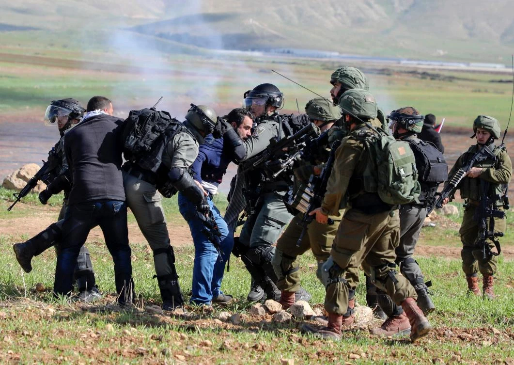 Israeli soldiers arrest a Palestinian protester during a demonstration against a US brokered Middle East peace plan outside the West Bank village of Tamun near the Jordan Valley on Jan. 31, 2020. (AFP)