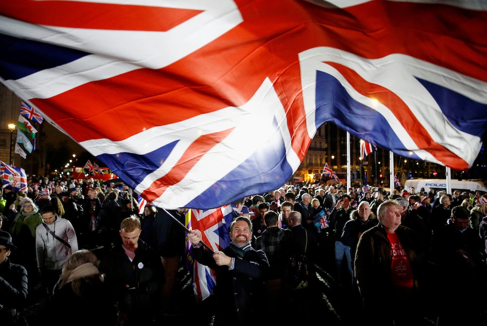 A gathering of jubilant Brexit supporters have outside Parliament Square are celebrating the UK's exit from the EU on Friday. (Reuters)