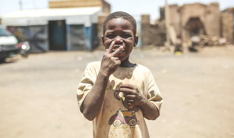 A poor child plays in dusty conditions, as Sudanese economy lays in tatters. (AP)