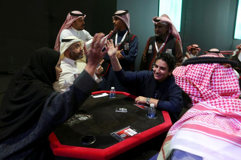 Women play a popular card game "Baloot" against men, as Saudi women join a local Baloot tournament for the first time, in Riyadh, Saudi Arabia. (Reuters)