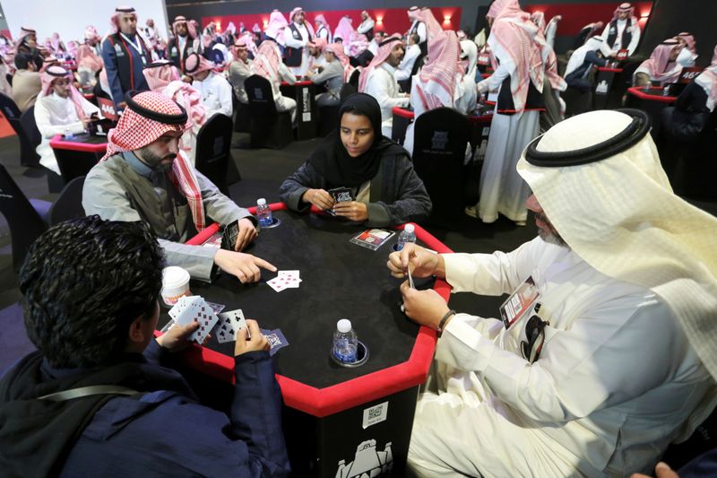 Women play a popular card game "Baloot" against men, as Saudi women join a local Baloot tournament for the first time, in Riyadh, Saudi Arabia. (Reuters)