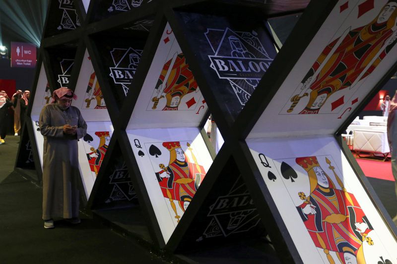 A Saudi man prepares to participate in the "Baloot" card-playing competition, as Saudi women join a local Baloot tournament for the first time, in Riyadh, Saudi Arabia. (Reuters)