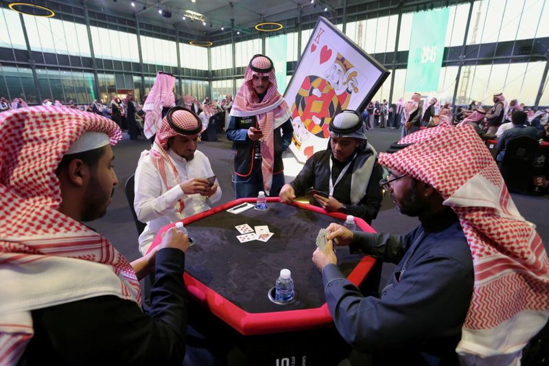 Saudi men play the popular card game "Baloot", as Saudi women join a local Baloot tournament for the first time, in Riyadh, Saudi Arabia. (Reuters)