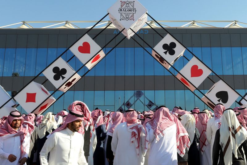 Saudi men gather in front of the Baloot Games Hall to participate in the "Baloot" card-playing competition, as Saudi women join a local Baloot tournament for the first time, in Riyadh, Saudi Arabia. (Reuters)