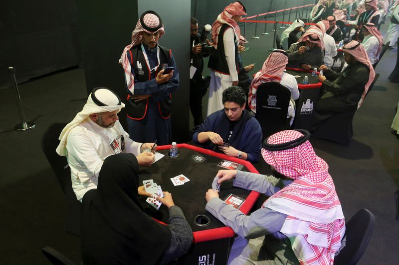 Women play a popular card game "Baloot" against men, as Saudi women join a local Baloot tournament for the first time, in Riyadh, Saudi Arabia. (Reuters)