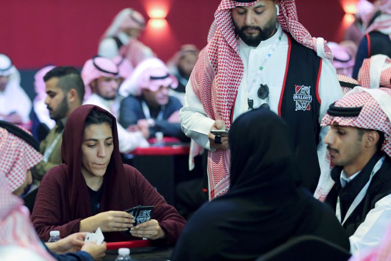 Women play a popular card game "Baloot" against men, as Saudi women join a local Baloot tournament for the first time, in Riyadh, Saudi Arabia. (Reuters)