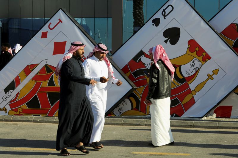 Saudi men at the "Baloot" card-playing competition, as Saudi women join a local Baloot tournament for the first time, in Riyadh, Saudi Arabia. (Reuters)