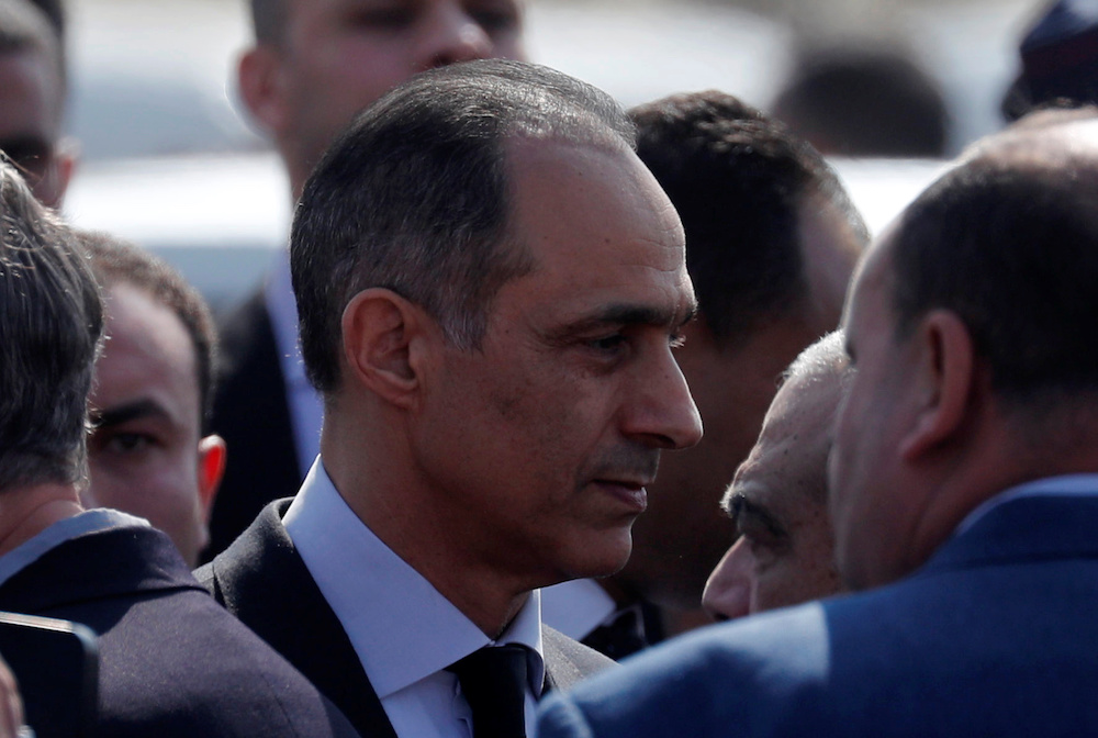 Gamal, son of former Egyptian President Hosni Mubarak, is consoled during his father's funeral east of Cairo. (Reuters)