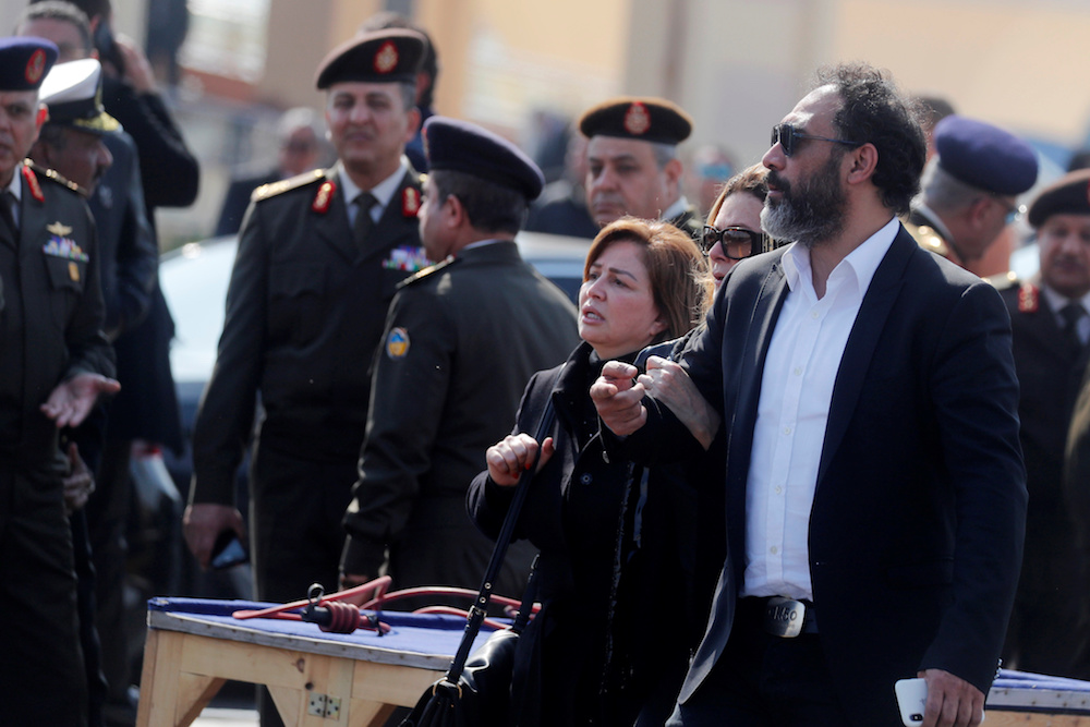 Egyptian actress Elham Shaheen and singer Amr Mostafa react during the funeral of former Egyptian President Hosni Mubarak east of Cairo. (Reuters)